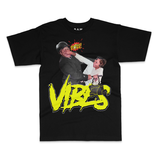 Black tee with a woman punching a helmeted man, POW! burst and neon yellow VIBES lettering – BY ANY MEANS by 2ManyLookz